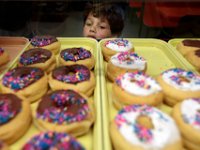 1008020024 ma nb MasDonuts  Zachary Aguiar, 6, takes a closer look at the chocolate frosted donuts at Ma's Donuts on Acushnet Avenue in the north end of New Bedford.   PETER PEREIRA : food, restaurant, eat, morning, breakfast, work, labor
